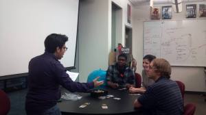 A group sitting around a table talking to each other.